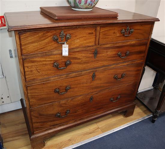 A George III mahogany chest fitted two short drawers and three long drawers on shaped bracket feet, with original gilt brass furniture